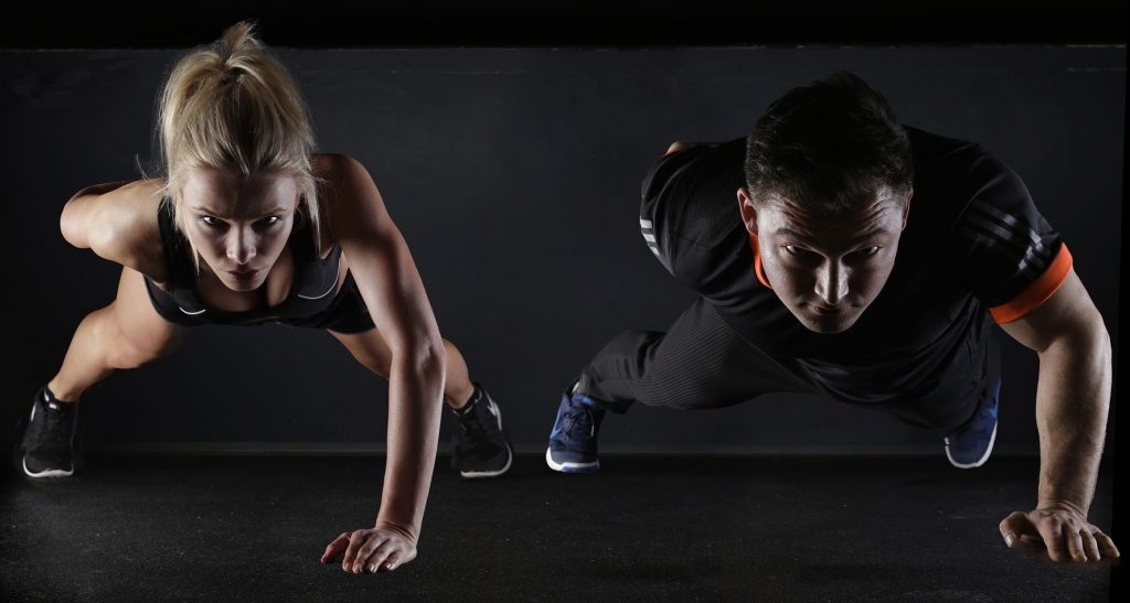 How to Create an Effective Workout Routine at Home. Man and Woman Push-Ups Hold Workout Couple Exercise for Wellness