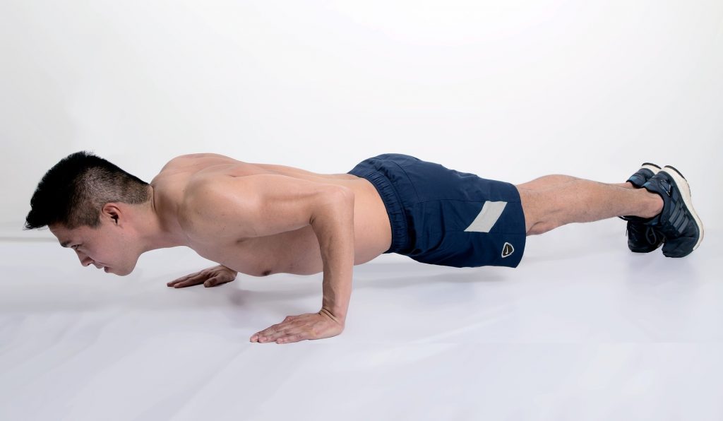 Sport Push-ups Exercise Young Man's Face, Bodybuilding Man - Best Upper Body Workout at Home with No Equipment.